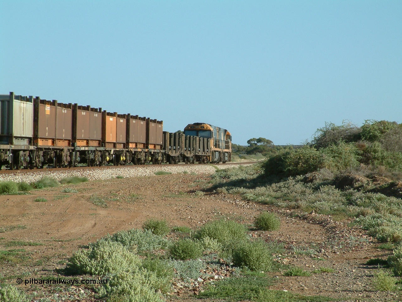 030404 082831
Port Germein, Perth bound steel and intermodal hurries through on the main behind National Rail's Goninan built GE Cv40-9i model NR class units NR 30 serial 7250-06 / 97-236 and a sister unit. 4th April 2003.
