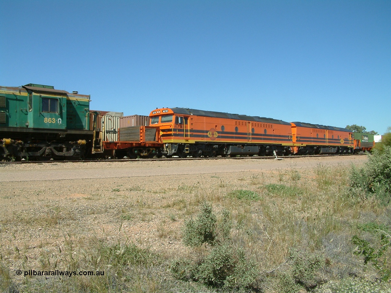 030404 131855
Port Augusta Spencer Junction yard, MKA (Morrison Knudsen Australia) rebuilt AL class AL 24 into EMD JT26C-2M model for Australian National in 1993 as the ALF class, here ALF 20 serial 94-AB-020 shunts empty rail transport waggon sets from the Darwin construction. 4th April, 2003.
Keywords: ALF-class;ALF20;MKA;EMD;JT26C-2M;94-AN-020;rebuild;AL-class;AL24;Clyde-Engineering;EMD;JT26C;76-840;