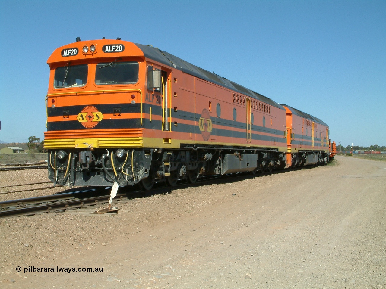 030404 141457
Port Augusta Spencer Junction yard, MKA (Morrison Knudsen Australia) rebuilt AL class AL 24 into EMD JT26C-2M model for Australian National in 1993 as the ALF class, here ALF 20 serial 94-AB-020 shunts empty rail transport waggon sets from the Darwin construction. 4th April, 2003.
Keywords: ALF-class;ALF20;MKA;EMD;JT26C-2M;94-AN-020;rebuild;AL-class;AL24;Clyde-Engineering;EMD;JT26C;76-840;