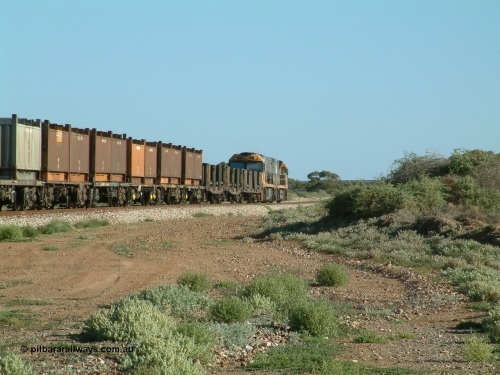 030404 082831
Port Germein, Perth bound steel and intermodal hurries through on the main behind National Rail's Goninan built GE Cv40-9i model NR class units NR 30 serial 7250-06 / 97-236 and a sister unit. 4th April 2003.

