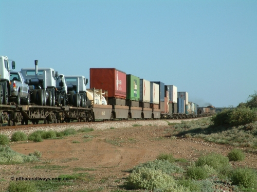 030404 082858
Port Germein, Perth bound steel and intermodal hurries through on the main behind National Rail's NR class units, showing one and a half stacking and new vehicles on flat waggons. 4th April 2003.
