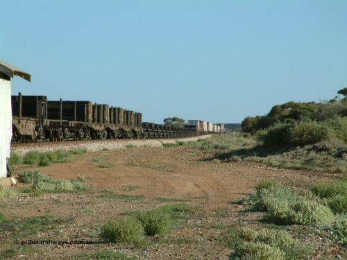 030404 083001
Port Germein, Perth bound steel and intermodal hurries through on the main with empty steel loading on the rear. 4th April 2003.
