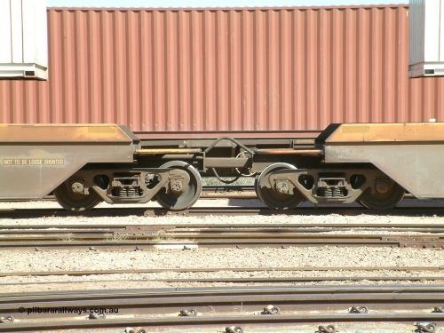 030404 104454
Port Augusta, Spencer Junction yard, RQZY type five unit bar coupled well container waggon RQZY 7050 built as one of a batch of thirty two by Goninan NSW for National Rail, detail of the bar coupling arrangement. 4th April, 2003.
Keywords: RQZY-type;RQZY7050;Goninan-NSW;1995-96/32-16;