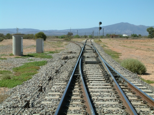 030404 120231
Stirling North, looking east from Port Augusta, line to Stirling North yard and Leigh Creek curves away to the left, line to Port Augusta power is right at bottom of frame.
