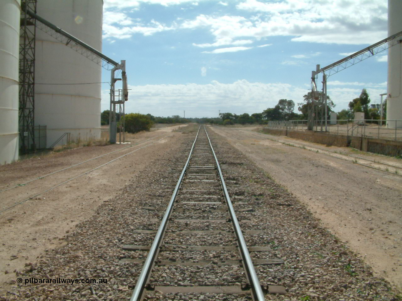 030405 140124
Kyancutta, yard view looking north along the mainline with silo out-loading spouts on each siding, 5th April 2003.
