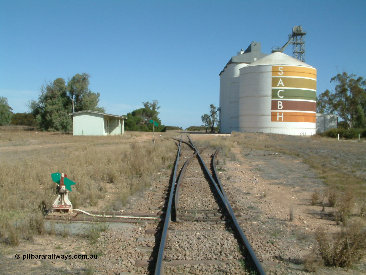 030405 145520
Warramboo, yard overview looking south with siding point levers and indicators, station building on left and Ascom style silo complex in front of concrete SACBH silo complex, 5th April 2003.
