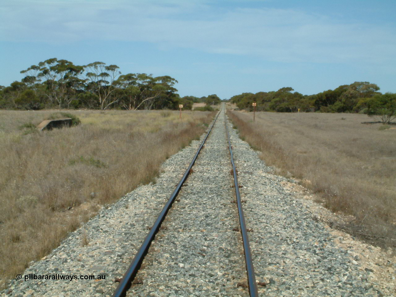 030405 153114
McLachlan, station located at the 156 km, originally opened in September 1914 and called 97 Miles till 1915, closed in August 1972, view looking south with remains of loading ramp at left and square W boards for 'whistle', 5th April 2003.
