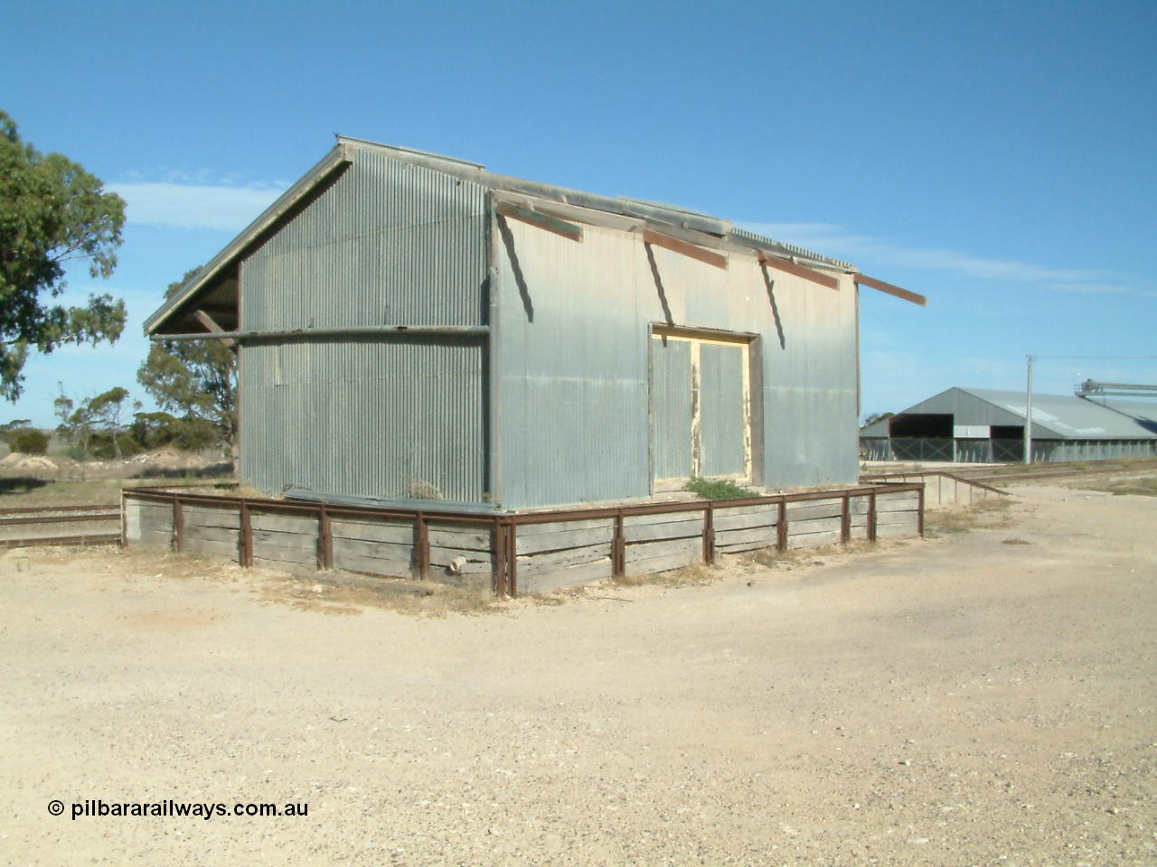 030405 155007
Lock, view of the goods shed and platform dating from circa 1938 with half the roof missing, horizontal grain shed visible in the background, 5th April 2003.
