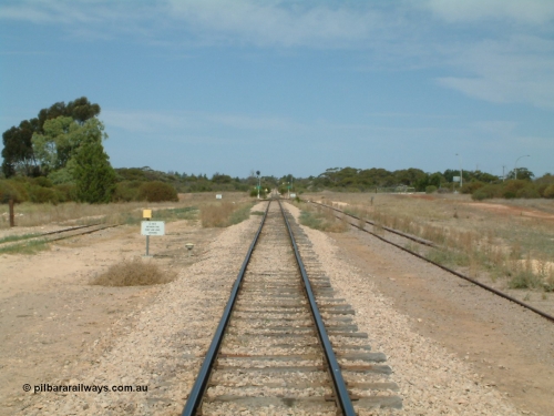 030405 140050
Kyancutta, yard view looking south along the narrow gauge mainline with the Eyre Highway grade crossing in the distance and one of only two electrically lit signals on the Eyre Peninsula Division. April 5, 2003.
