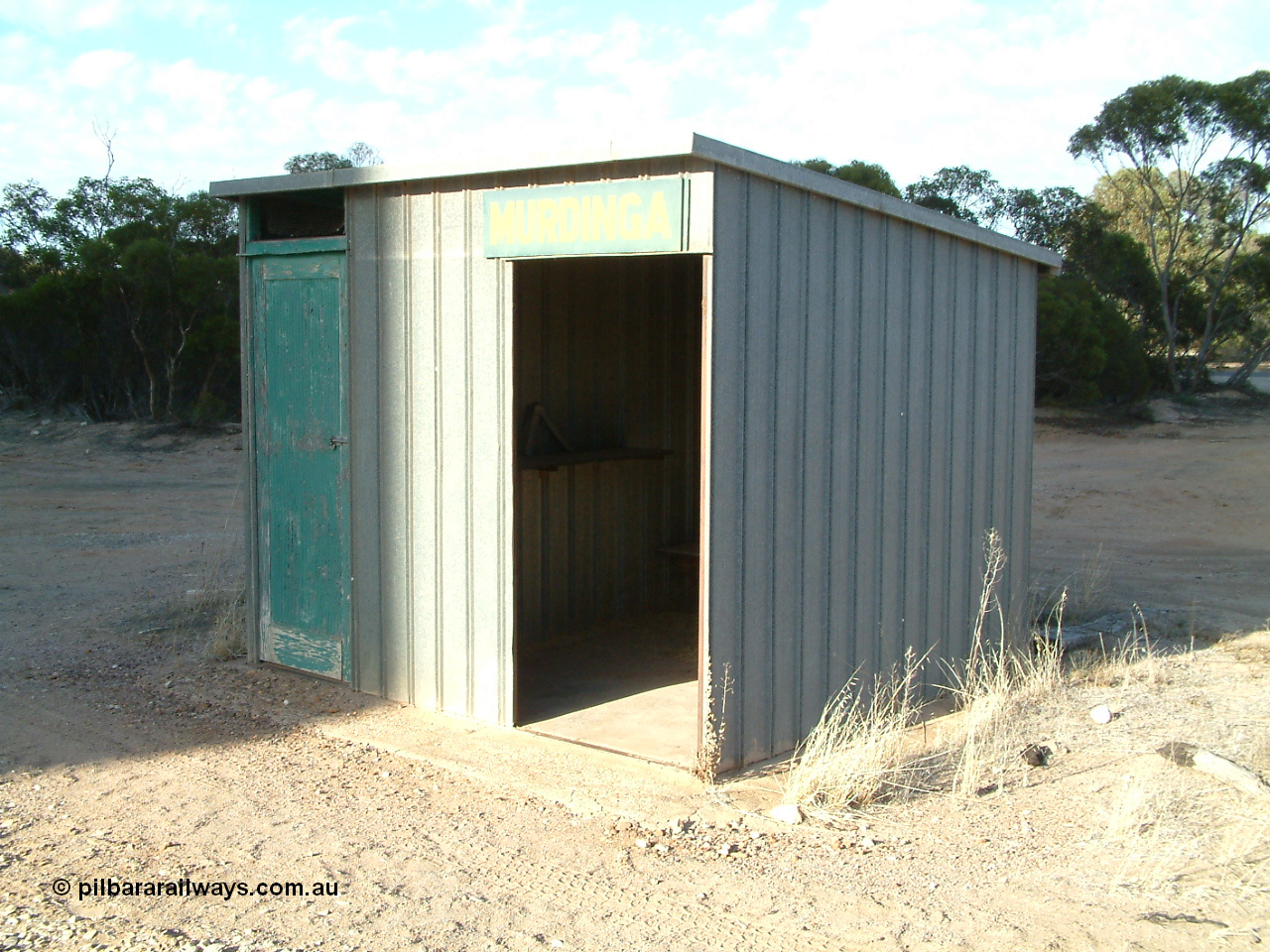 030406 082550
Murdinga, station located at the 128.2 km, originally opened December 1935 and originally referred to as Corunna, train control cabin and waiting room - shelter with station name board, 6th April 2003.
