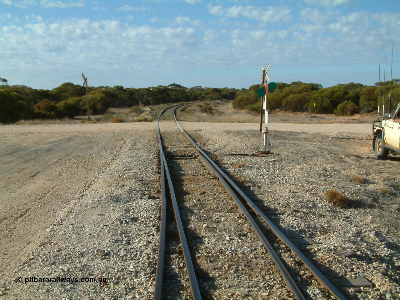 030406 082802
Murdinga, track view looking south across the grade crossing for Murlong Rd, points, indicator and lever, 6th April 2003.
