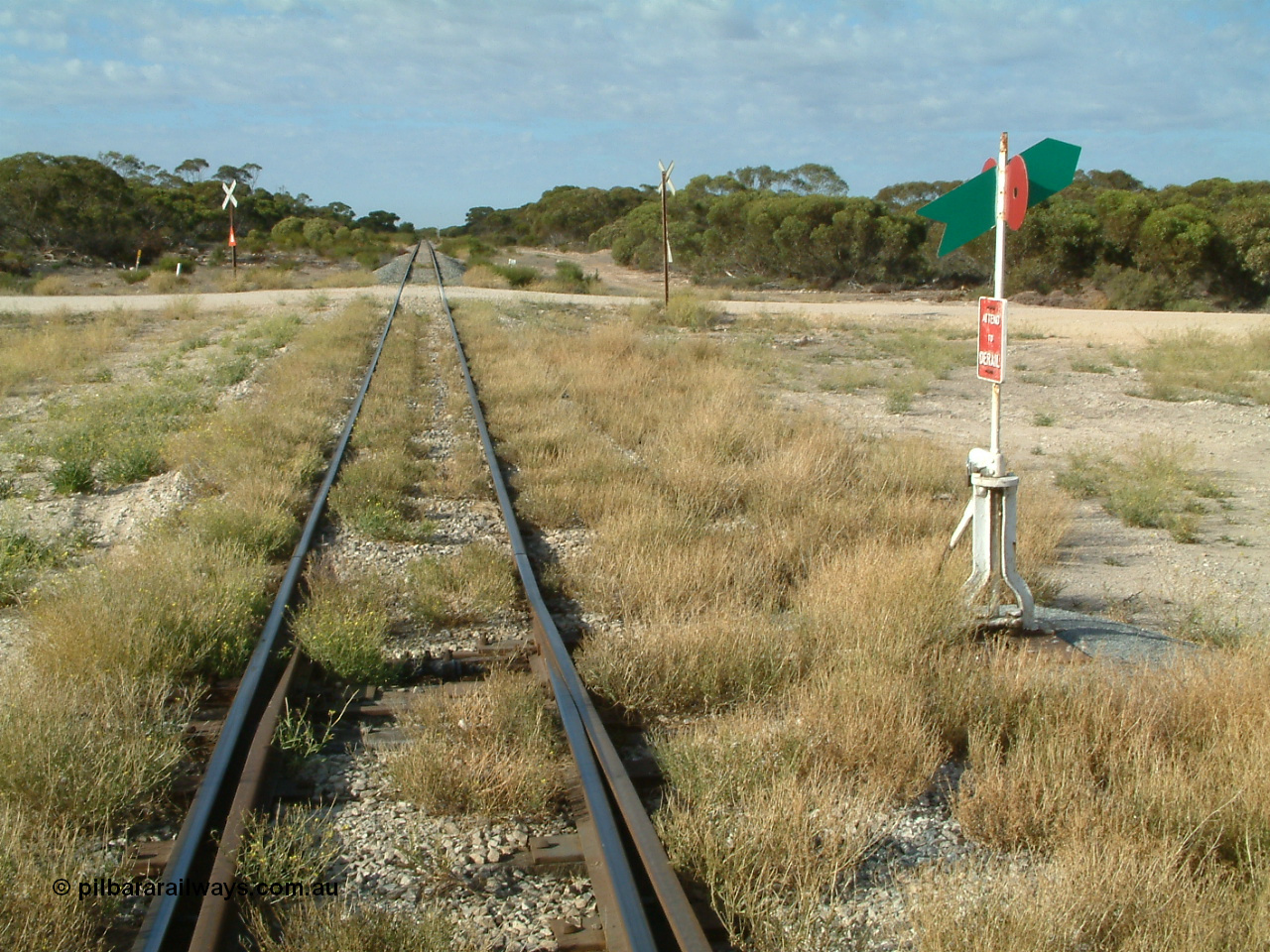 030406 084652
Tooligie, track view looking south from the south end points of yard, point lever and indicator, Tooligie Rd grade crossing, 6th April 2003.
