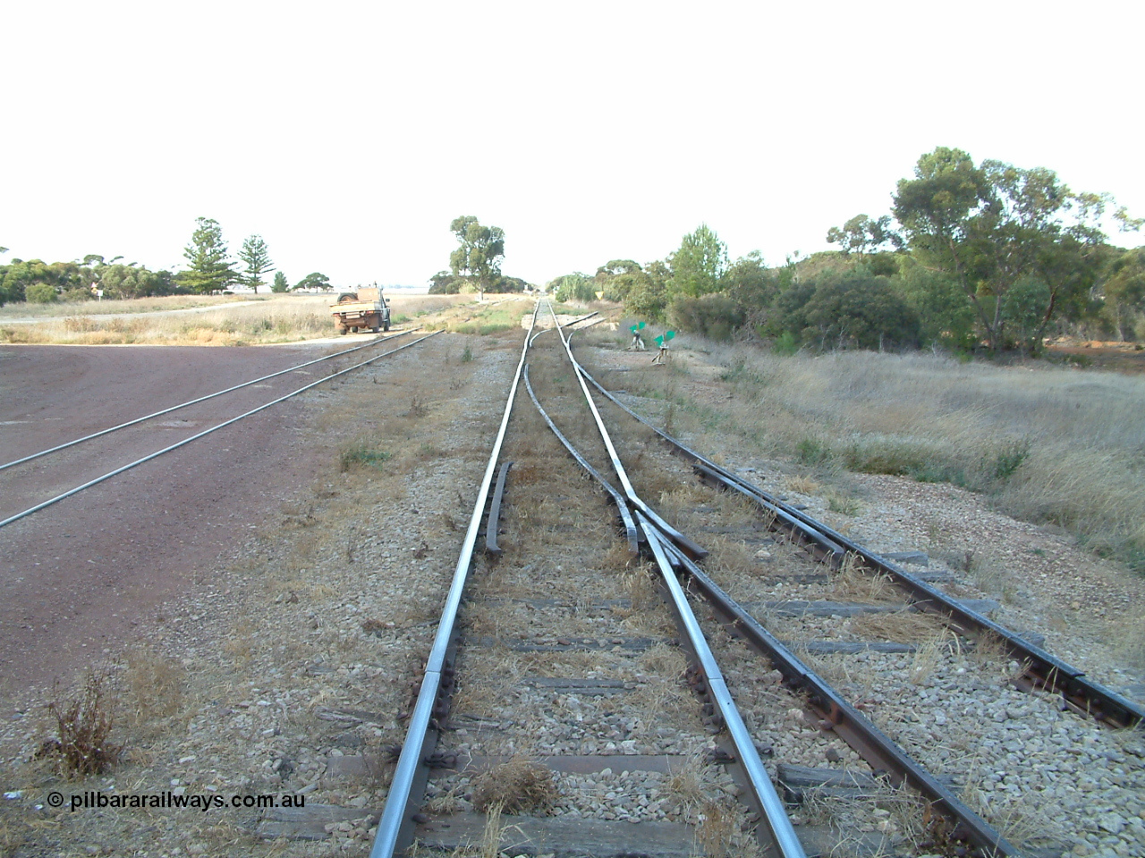 030406 092548
Yeelanna, yard view looking south along the mainline, with points and converging track from the station siding visible on the right, and the points, lever and indicator for the diverging line to Kapinnie and former Mount Hope branch curving to the right. 6th April 2003.
