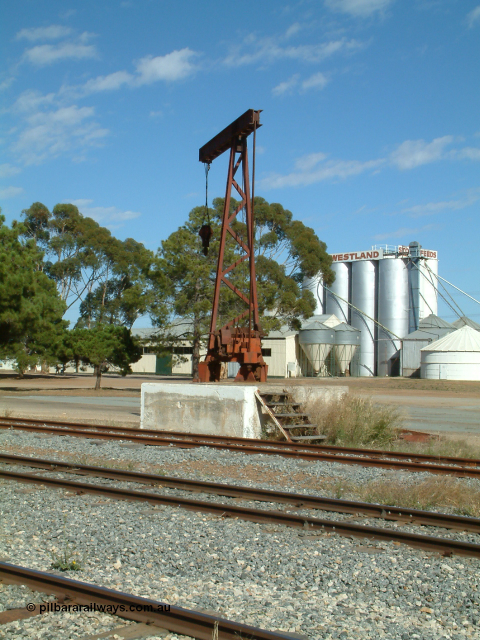 030406 095314
Cummins, 5 ton revolving jib crane on plinth, tracks from camera are Buckleboo line - siding, mainline and grain siding. 6th April 2003.
