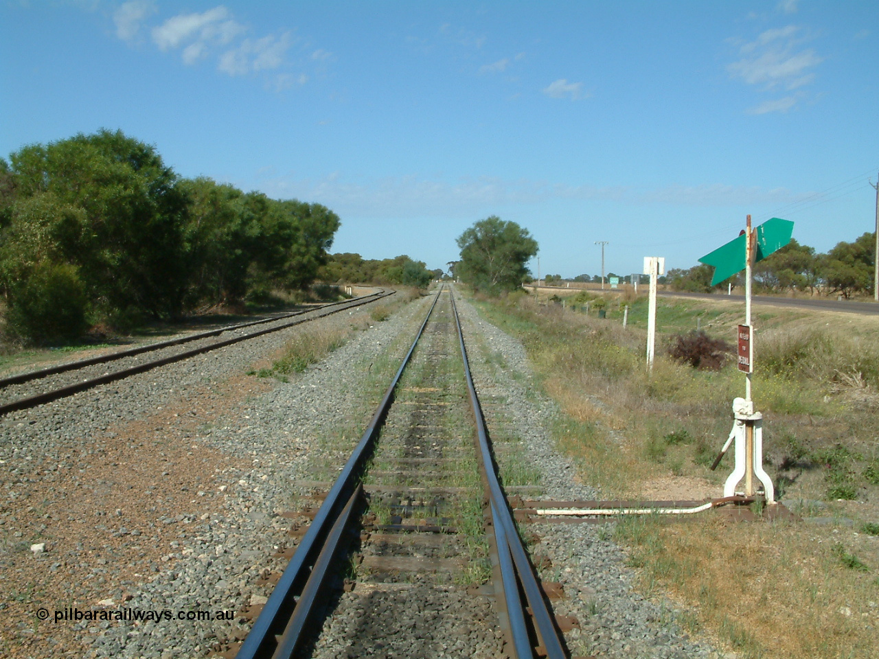 030406 100404
Cummins, track view looking south, points, lever and indicator for the goods and grain siding, on the left the grain bunker loading - unloading site track can be seen curving away to the left. The Todd Highway is at the far right. 6th April 2003.
