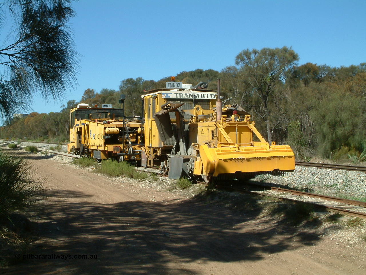 030406 110700
Coomunga, on the siding, two Transfield track machines, TMN 02, a ballast regulator and a track tamper. 6th April 2003.
Keywords: track-machine;