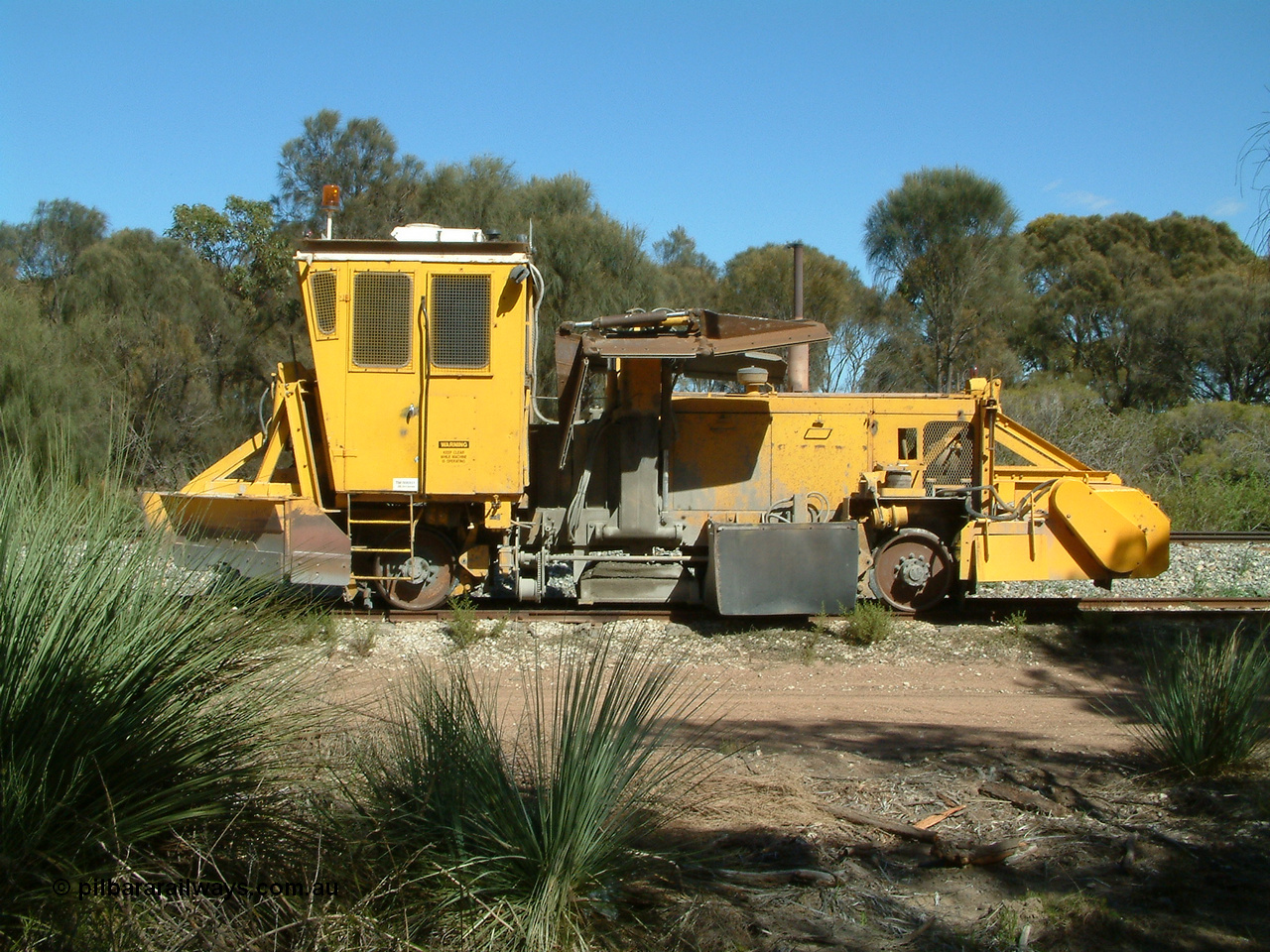 030406 110810
Coomunga, stabled on the siding, Transfield track machine ballast regulator. 6th April 2003.
Keywords: track-machine;