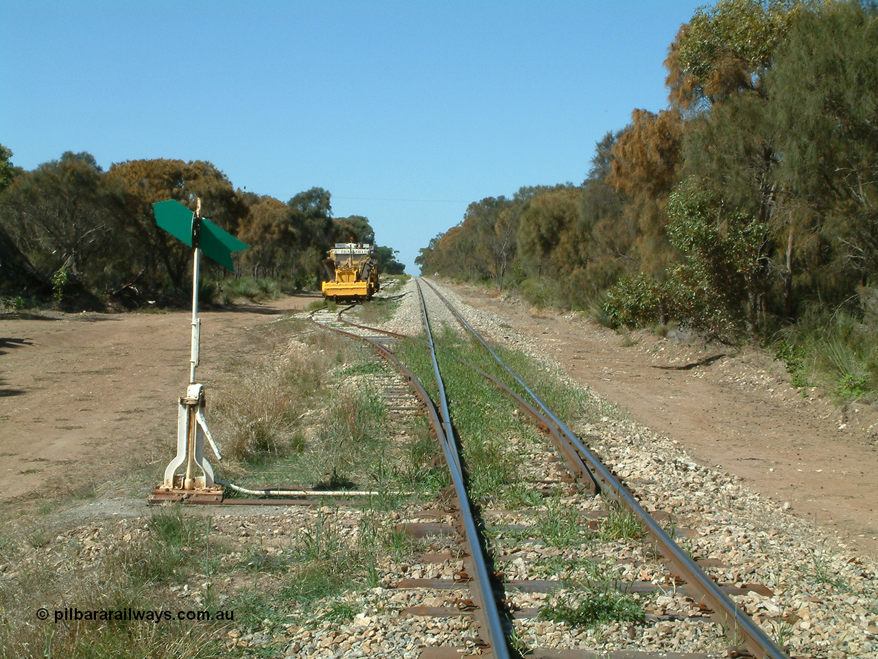 030406 110950
Coomunga, station located at the 21.6 km, opened in November 1907, used these days as a track maintenance siding. Yard overview looking south from the north end points, track machines on the left. 6th April 2003.
