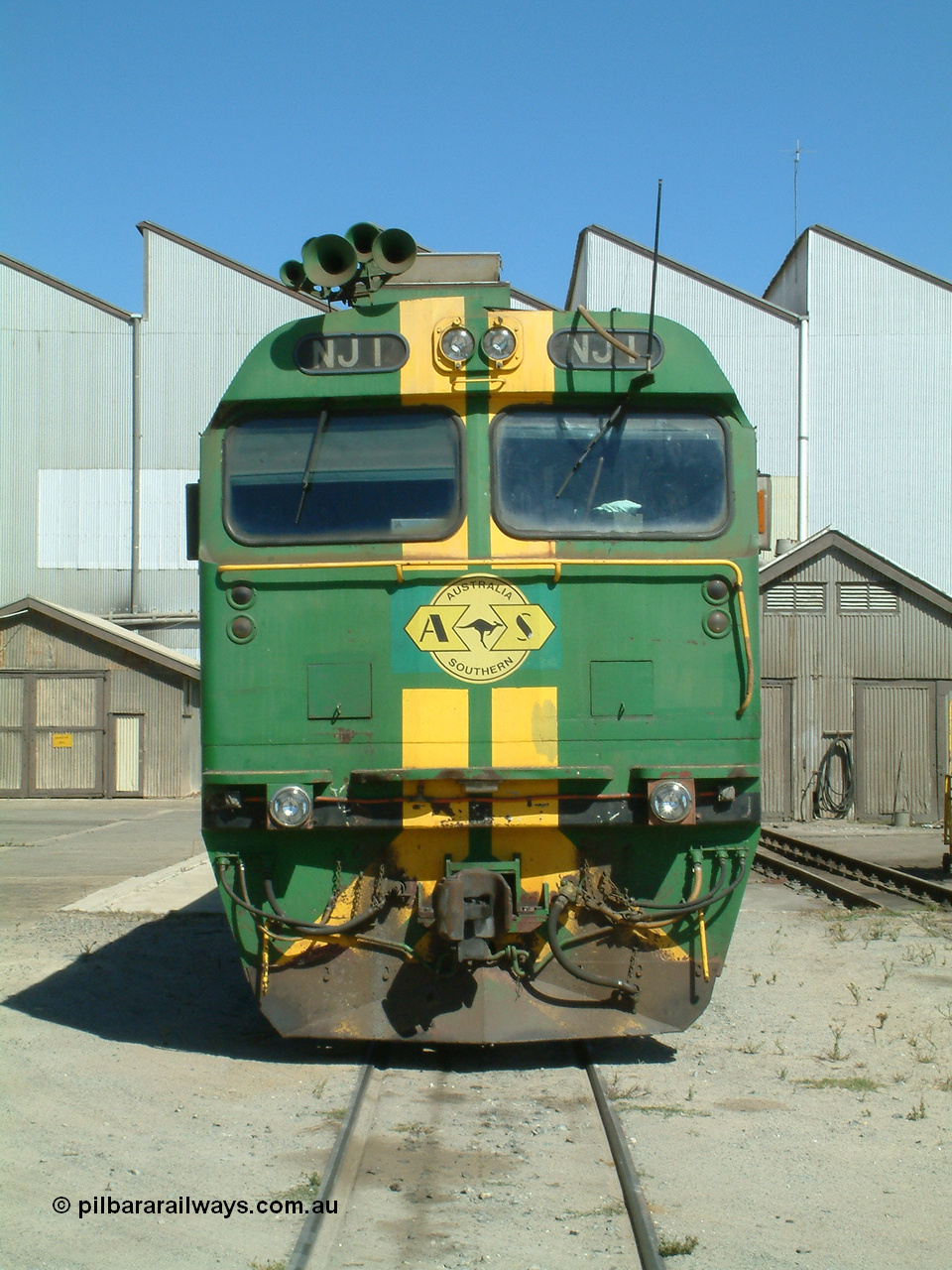 030406 113716
Port Lincoln loco workshops, still wearing the former owner's AN livery, Australian Southern locomotive and NJ class leader NJ 1 'Ben Chifley' Clyde Engineering EMD model JL22C serial 71-728, cab front view. 6th April 2003.
Keywords: NJ-class;NJ1;71-728;Clyde-Engineering-Granville-NSW;EMD;JL22C;