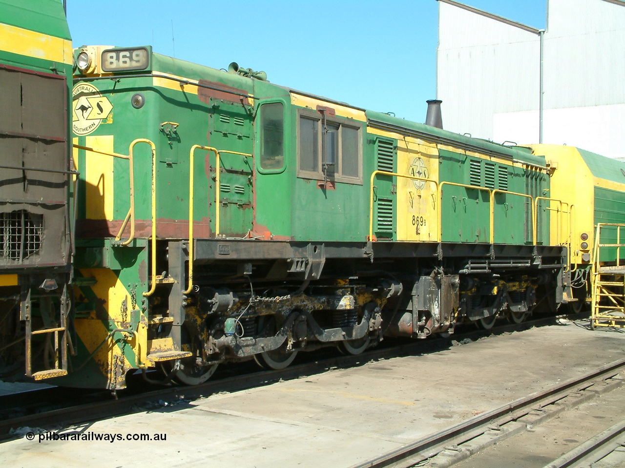 030406 113830
Port Lincoln loco workshops, still wearing the former owner's AN livery, Australian Southern locomotive 830 class 869 AE Goodwin ALCo model DL531 serial G6016-05 with the check letter of B, sandwiched between two NJ class units. 6th April 2003.
Keywords: 830-class;869;G6016-5;AE-Goodwin;ALCo;DL531;