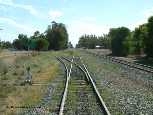 030406 100330
Cummins, yard overview looking north from the south end of the yard down the mainline. Points, lever and indicator for the goods and grain siding, the tracks on the right run behind the camera to the grain bunker loading - unloading site. April 6, 2003.
