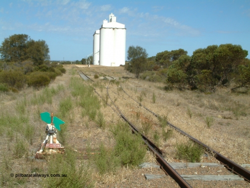 030406 141806
Kapinnie, station yard overview looking east towards Yeelanna, dwarf point lever and indicator, concrete silo complexes with outflow spouts. April 6, 2003.
