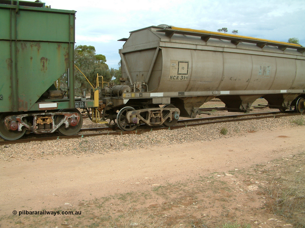 030407 082440
Wudinna, detail view of HCN type bogie wheat waggon HCN 31, modified at Islington Workshops in 1978-80 which started life as a Tulloch built NHB type iron ore hopper for the CR on the North Australia Railway in 1968-69, showing a spoke wheel and disc wheel sets in the bogie. 7th April 2003.
Keywords: HCN-type;HCN31;SAR-Islington-WS;rebuild;Tulloch-Ltd-NSW;NHB-type;NHB1579;