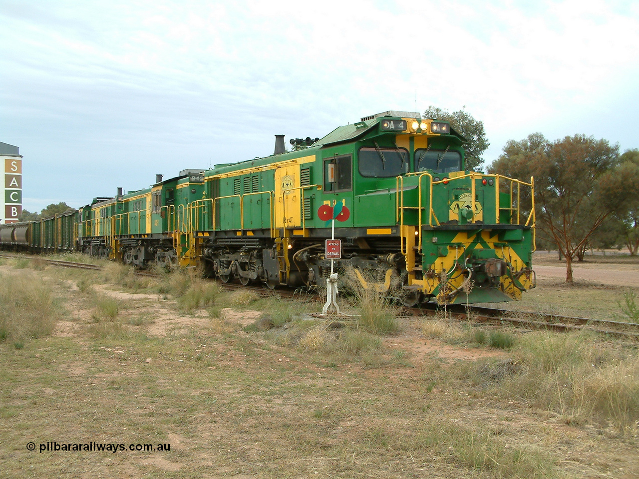 030407 082757
Wudinna, empty grain train shunts back into the grain siding with a trio of former Australian National Co-Co locomotives with rebuilt former AE Goodwin ALCo model DL531 830 class ex 839, serial no. 83730, rebuilt by Port Augusta Workshops to DA class, DA 4 leading two AE Goodwin ALCo model DL531 830 class units 842, serial no. 84140 and 851 serial no. 84137, 851 having been on the Eyre Peninsula since delivered in 1962. 7th April, 2003.
Keywords: DA-class;DA4;83730;Port-Augusta-WS;ALCo;DL531G/1;830-class;839;rebuild;