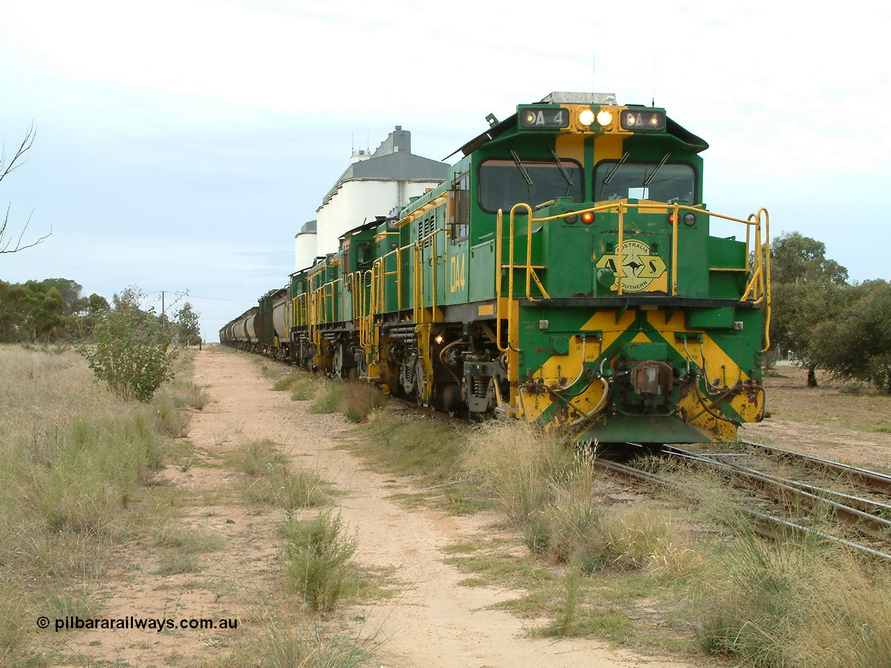 030407 083438
Wudinna, empty grain stands on the main awaiting departure north with a trio of former Australian National Co-Co locomotives with rebuilt former AE Goodwin ALCo model DL531 830 class ex 839, serial no. 83730, rebuilt by Port Augusta Workshops to DA class, leading two AE Goodwin ALCo model DL531 830 class units 842, serial no. 84140 and 851 serial no. 84137, 851 having been on the Eyre Peninsula since delivered in 1962. 7th April, 2003.
Keywords: DA-class;DA4;83730;Port-Augusta-WS;ALCo;DL531G/1;830-class;839;rebuild;