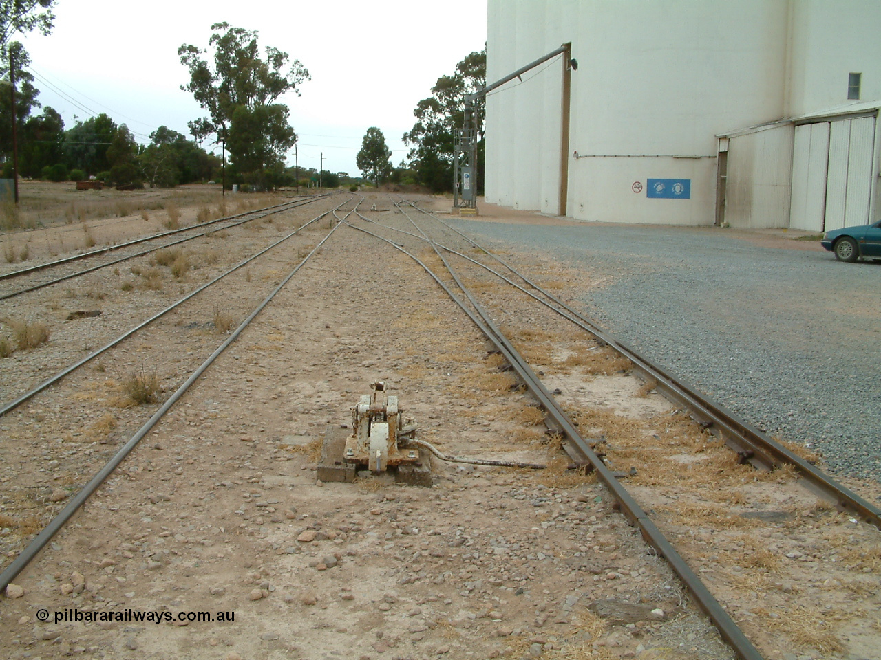 030407 094517
Minnipa, yard view looking south with cheese knob point lever for sidings, mainline is third from the right, silo out-flow spout. 7th April, 2003.
