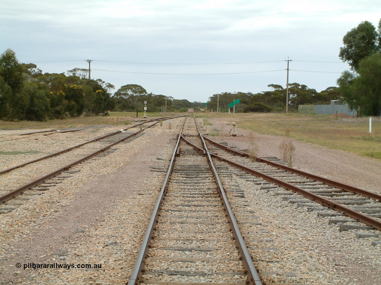 030407 094908
Minnipa, station yard overview looking north from the middle of the yard. Sidings 2 and 3 coming in from the left and Siding 1 on the right, point levers and indicators. Grade crossing in the distance. 7th April 2003.
