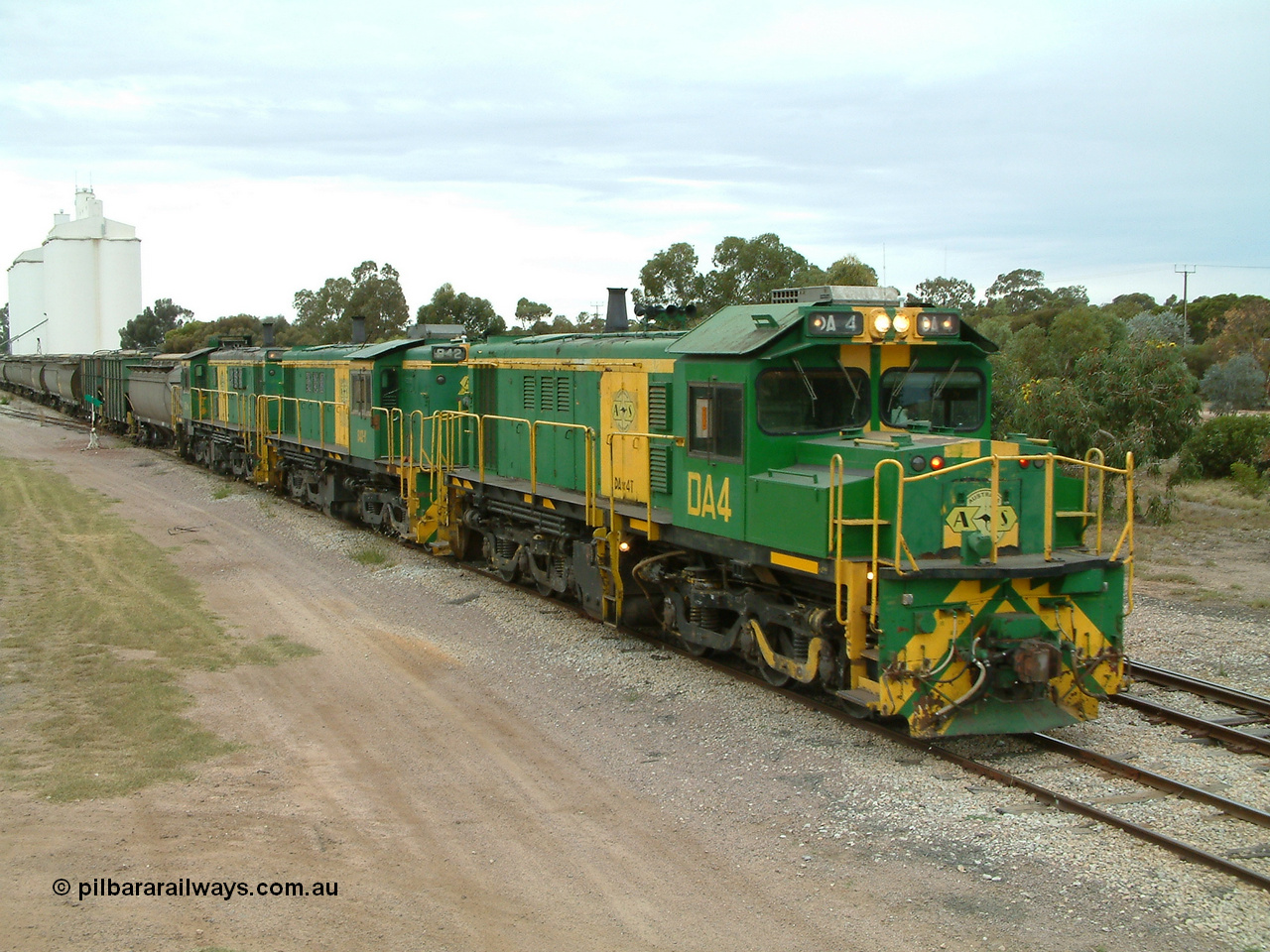 030407 100445
Minnipa, north bound empty grain train arrives behind a trio of former Australian National Co-Co locomotives with rebuilt former AE Goodwin ALCo model DL531 830 class ex 839, serial no. 83730, rebuilt by Port Augusta Workshops to DA class, leading two AE Goodwin ALCo model DL531 830 class units 842, serial no. 84140 and 851 serial no. 84137, 851 having been on the Eyre Peninsula since delivered in 1962, to shunt off empty waggons into the grain siding. 7th April, 2003.
Keywords: DA-class;DA4;83730;Port-Augusta-WS;ALCo;DL531G/1;830-class;839;rebuild;