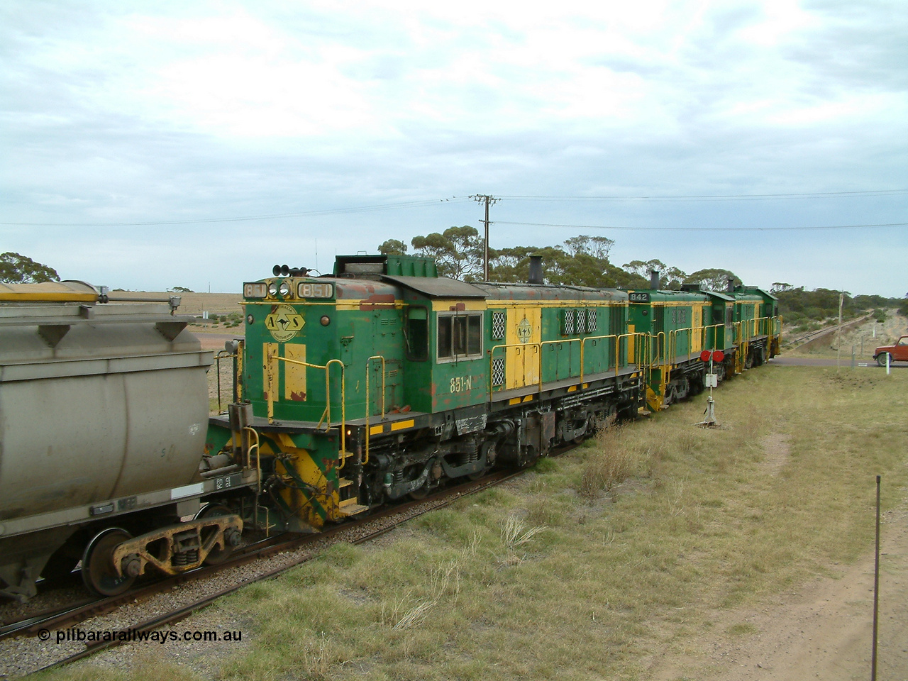 030407 100834
Minnipa, empty grain train shunts back into the grain siding with a trio of former Australian National Co-Co locomotives with rebuilt former AE Goodwin ALCo model DL531 830 class ex 839, serial no. 83730, rebuilt by Port Augusta Workshops to DA class, leading two AE Goodwin ALCo model DL531 830 class units 842, serial no. 84140 and 851 serial no. 84137, 851 having been on the Eyre Peninsula since delivered in 1962. 7th April, 2003.
Keywords: 830-class;851;AE-Goodwin;ALCo;DL531;84137;