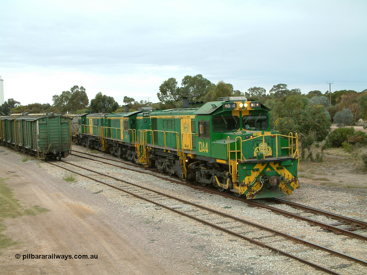 030407 100858
Minnipa, empty grain train shunts back into the grain siding with a trio of former Australian National Co-Co locomotives with rebuilt former AE Goodwin ALCo model DL531 830 class ex 839, serial no. 83730, rebuilt by Port Augusta Workshops to DA class, leading two AE Goodwin ALCo model DL531 830 class units 842, serial no. 84140 and 851 serial no. 84137, 851 having been on the Eyre Peninsula since delivered in 1962. 7th April, 2003.
Keywords: DA-class;DA4;83730;Port-Augusta-WS;ALCo;DL531G/1;830-class;839;rebuild;