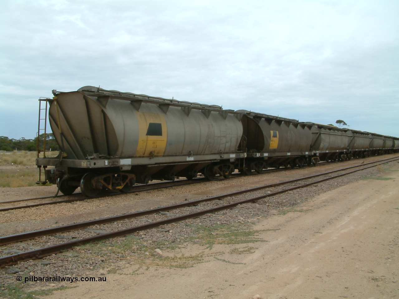 030407 105044
Poochera, loaded SAR Islington Workshops built HAN type bogie wheat waggon HAN 46, at the head of a rake waiting collection. 7th April 2003.
Keywords: HAN-type;HAN46;1969-73/68-46;SAR-Islington-WS;