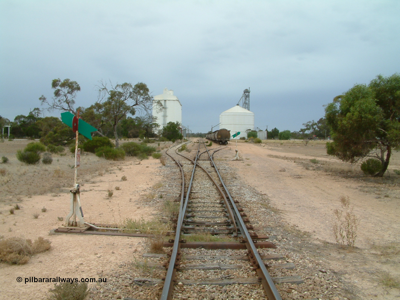 030407 105330
Poochera, yard overview looking south from the north end points, crane and goods shed just visible on the left of the goods siding. 7th April 2003.
