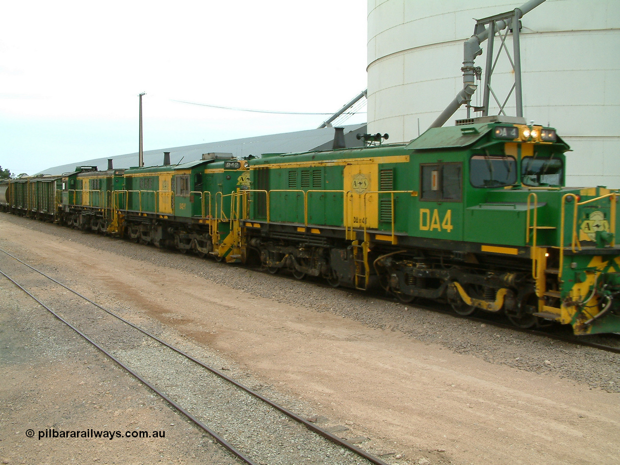 030407 114338
Poochera, empty grain train arrives behind a trio of former Australian National Co-Co locomotives with rebuilt former AE Goodwin ALCo model DL531 830 class ex 839, serial no. 83730, rebuilt by Port Augusta Workshops to DA class, DA 4 leading two AE Goodwin ALCo model DL531 830 class units 842, serial no. 84140 and 851 serial no. 84137, 851 having been on the Eyre Peninsula since delivered in 1962, to shunt off empty waggons and pick up the loaded ones. 7th April 2003.
Keywords: DA-class;DA4;83730;Port-Augusta-WS;ALCo;DL531G/1;830-class;839;rebuild;