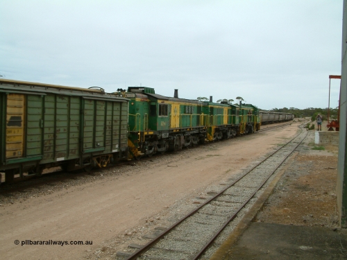 030407 114350
Poochera, empty grain train arrives behind a trio of former Australian National Co-Co locomotives with rebuilt former AE Goodwin ALCo model DL531 830 class ex 839, serial no. 83730, rebuilt by Port Augusta Workshops to DA class, DA 4 leading two AE Goodwin ALCo model DL531 830 class units 842, serial no. 84140 and 851 serial no. 84137, 851 having been on the Eyre Peninsula since delivered in 1962, to shunt off empty waggons and pick up the loaded ones. April 7, 2003.
Keywords: 830-class;851;AE-Goodwin;ALCo;DL531;84137;