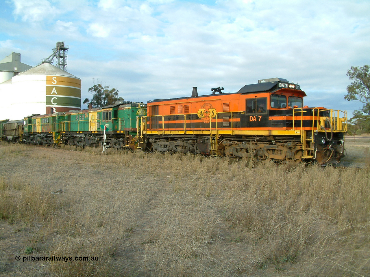 030409 080106
Warramboo, empty grain train arrives just after 0800 and stops for a crew change. Rebuild unit DA 7 in Australian Southern orange and black livery leads a pair of AE Goodwin built ALCo model DL531 830 class units 872 and 871.
Keywords: DA-class;DA7;83713;Port-Augusta-WS;ALCo;DL531G/1;48-class;4813;rebuild;