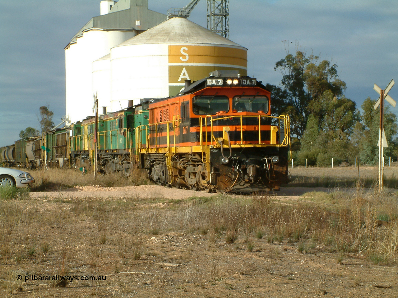 030409 080852
Warramboo, empty grain departs following a crew change. Rebuild unit DA 7 in Australian Southern orange and black livery leads a pair of AE Goodwin built ALCo model DL531 830 class units 872 and 871, the SACBH concrete silo and Ascom silo complexes behind it.
Keywords: DA-class;DA7;83713;Port-Augusta-WS;ALCo;DL531G/1;48-class;4813;rebuild;