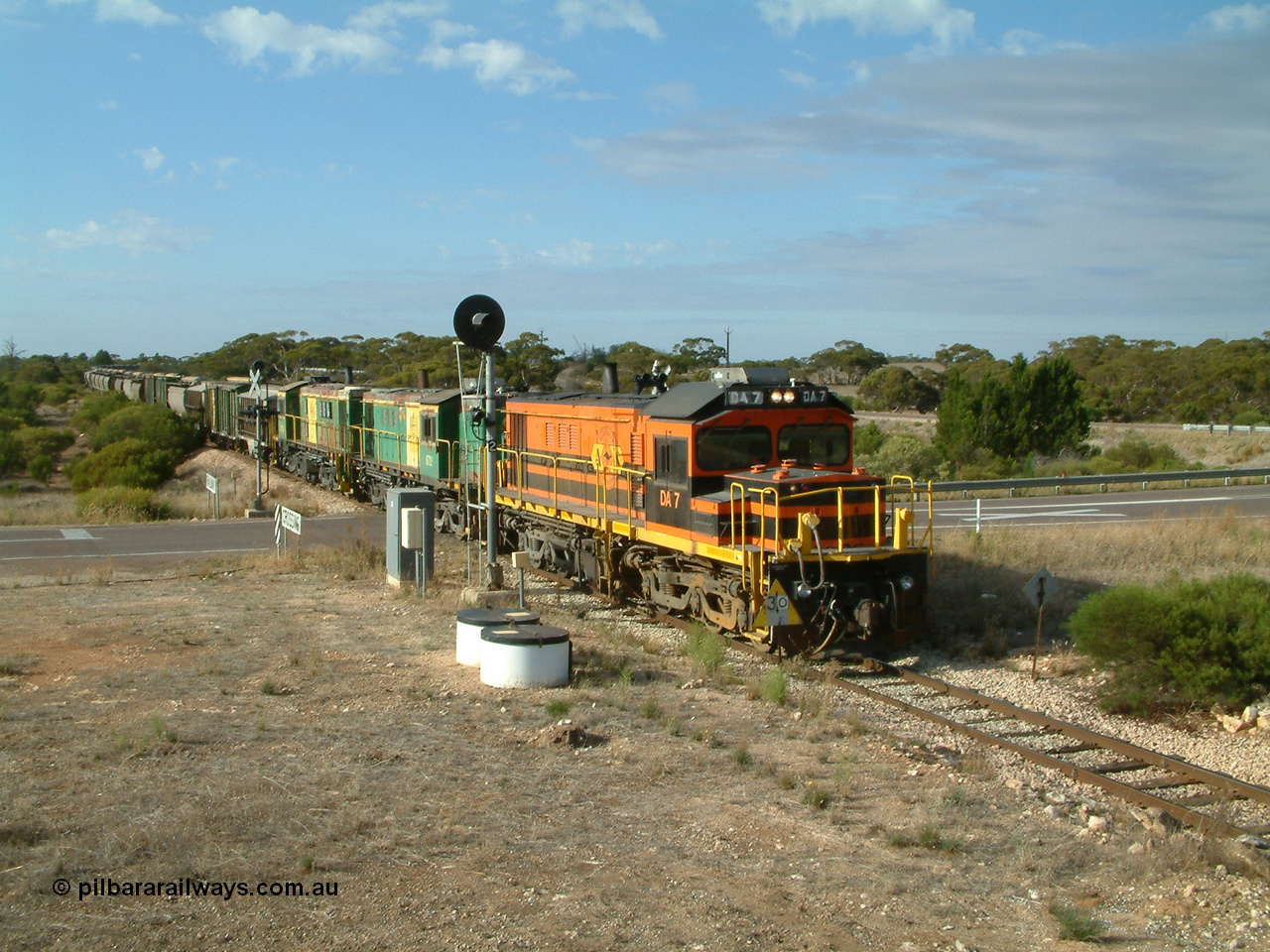 030409 084528
Kyancutta, empty grain train arrives across the Eyre Highway grade crossing behind rebuild DA class unit DA 7 in Australian Southern orange and black livery leading a pair of AE Goodwin built ALCo model DL531 830 class units 872 and 871 with a string of grain waggons.
Keywords: DA-class;DA7;83713;Port-Augusta-WS;ALCo;DL531G/1;48-class;4813;rebuild;