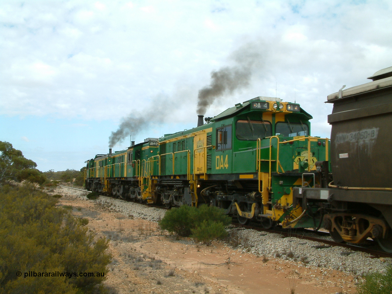 030409 121224
Kielpa, a few kilometres south of the former Konanda siding loaded grain train with 830 class unit 851 AE Goodwin ALCo model DL531 serial 84137, 851 has spent its entire operating career on the Eyre Peninsula, leads fellow 830 class 842 serial 84140 and a rebuilt unit DA 4, rebuilt from 830 class unit 839 by Port Augusta Workshops, retains original serial 83730 and model DL531 with the first twelve waggons behind the locos XNW type powers away from a crew change.
Keywords: DA-class;DA4;83730;Port-Augusta-WS;ALCo;DL531G/1;830-class;839;rebuild;