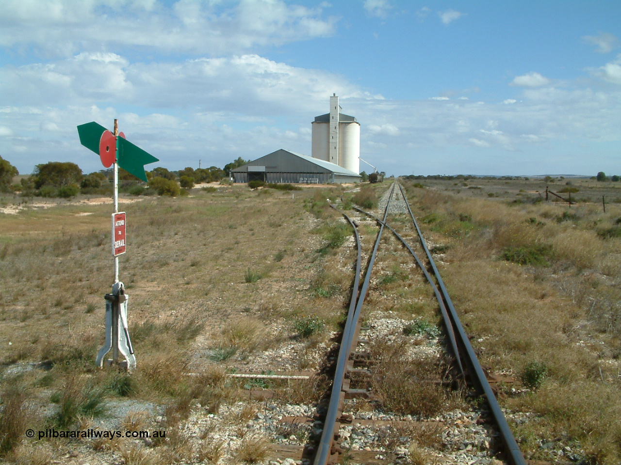 030409 135737
Wharminda, located at the 140.5 km and opened in July 1913, yard overview looking south from the north end, horizontal grain bunker with concrete silo complex behind, loaded grain waggons awaiting pick up.
