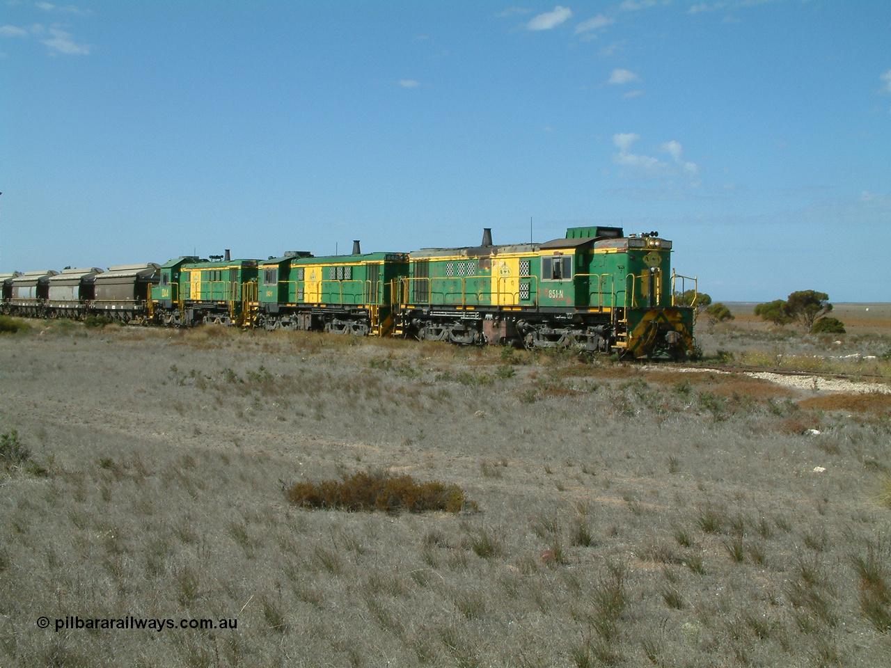030409 140546
Wharminda, loaded grain train arrives behind 830 class unit 851 AE Goodwin ALCo model DL531 serial 84137, 851 has spent its entire operating career on the Eyre Peninsula, with fellow 830 class 842 serial 84140 and a rebuilt unit DA 4 as they stop to pick up loaded waggons.
Keywords: 830-class;851;AE-Goodwin;ALCo;DL531;84137;