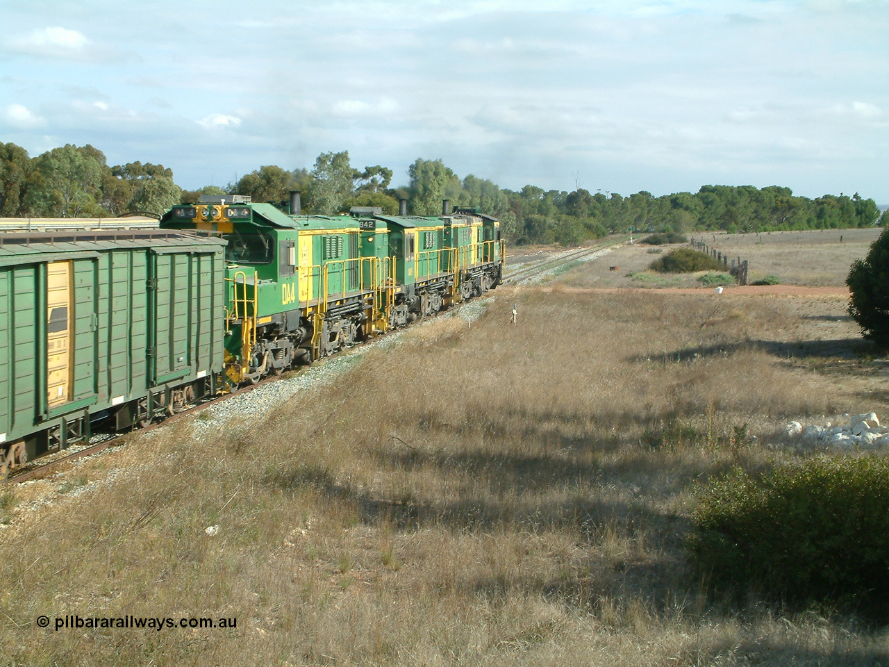 030409 152433
Ungarra, the peace is shattered as a loaded grain train storms upgrade through the station behind 830 class unit 851 AE Goodwin ALCo model DL531 serial 84137, fellow 830 class 842 serial 84140 and a rebuilt DA class unit DA 4 trailing view as the continue south.
Keywords: DA-class;DA4;83730;Port-Augusta-WS;ALCo;DL531G/1;830-class;839;rebuild;