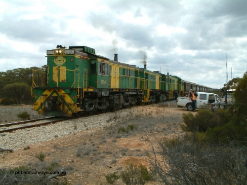 030409 121202
Kielpa, a few kilometres south of the former Konanda siding loaded grain train with 830 class unit 851 AE Goodwin ALCo model DL531 serial 84137, 851 has spent its entire operating career on the Eyre Peninsula, leads fellow 830 class 842 serial 84140 and a rebuilt unit DA 4, rebuilt from 830 class unit 839 by Port Augusta Workshops, retains original serial 83730 and model DL531 with the first twelve waggons behind the locos XNW type powers away from a crew change.
Keywords: 830-class;851;AE-Goodwin;ALCo;DL531;84137;