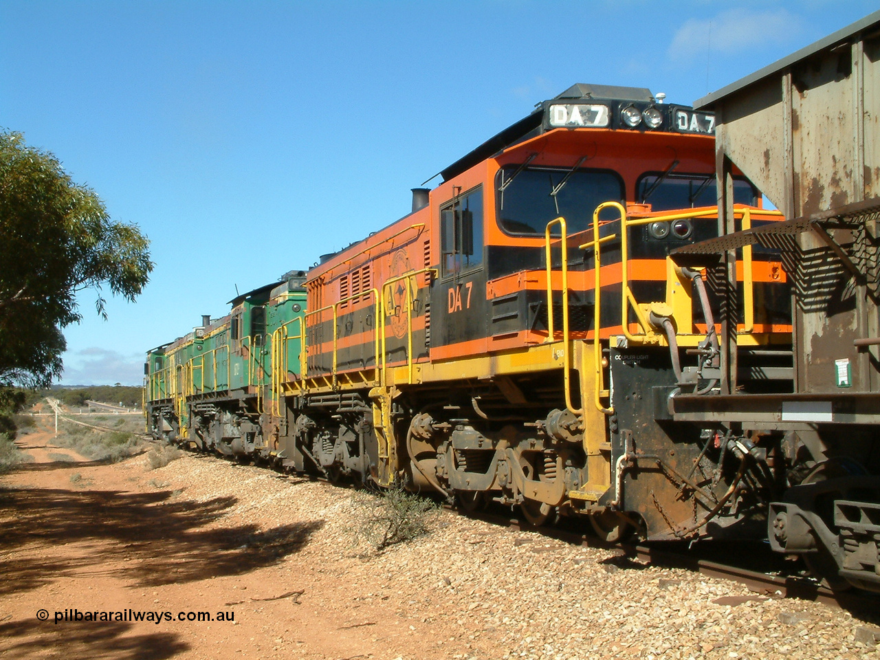 030411 102054
Kimba Grain Bunker, looking towards Kimba with Aerodrome Rd in the distance, ALCo DL531G/1 model rebuilt from an AE Goodwin made ALCo DL531 48 class 4813 serial 83713, issued to Eyre Peninsula from new in March 1966, and two 830 class units, 871 and 872 prepare to depart with a loaded. 11th April 2003. [url=https://goo.gl/maps/Et8bgaqpMnn]Geodata here[/url].
Keywords: DA-class;DA7;83713;Port-Augusta-WS;ALCo;DL531G/1;48-class;4813;rebuild;