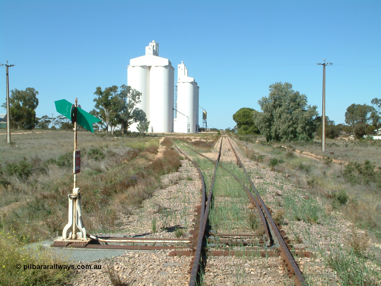 030411 141109
Nunjikompita, aboriginal word for 'burnt hair', located 357.6 km, terminus of line from 14th August 1914 until Thevenard extension opened on the 8th of February 1915, yard overview looking east from the western end of the yard. Concrete silo block 3 is closet to camera.
