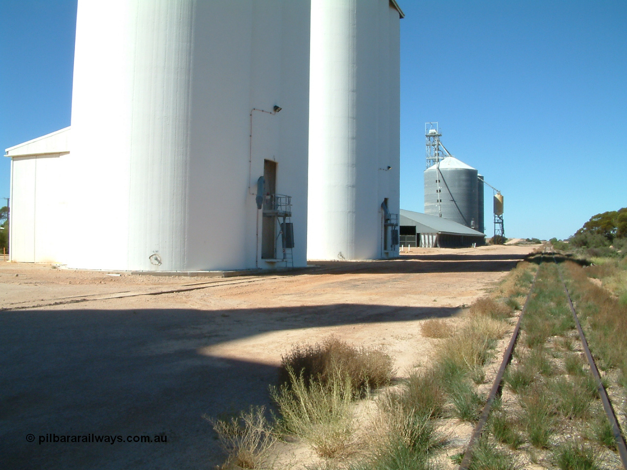 030411 141503
Nunjikompita, yard view looking east, concrete silo block 2, then 1, then a horizontal bunker then an Ascom style silo with loadout spout and silo.
