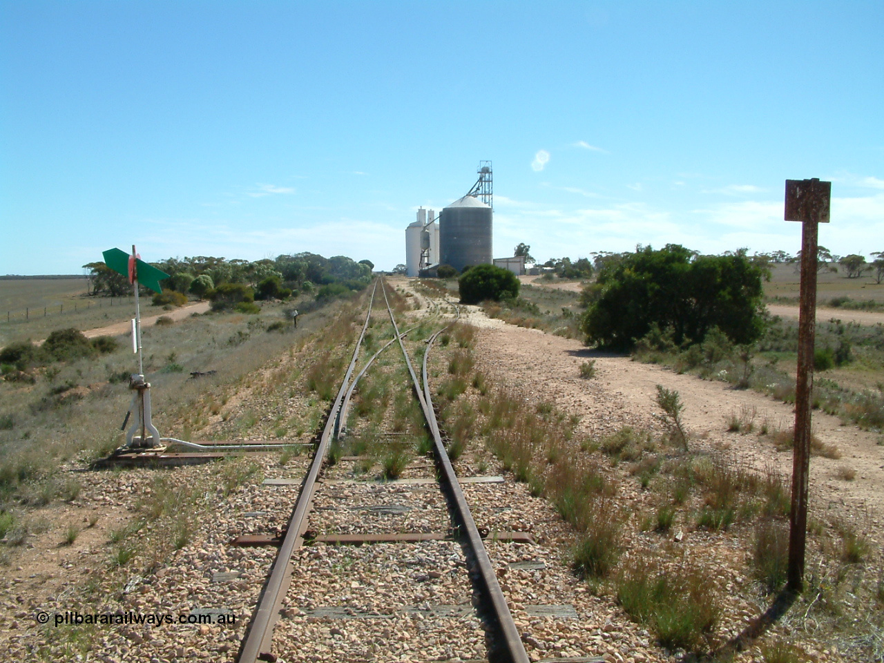 030411 141732
Nunjikompita, yard view looking west, Ascom style silo with loadout spout and silo, then a horizontal bunker and concrete silos. The truck unloading point is on the right of the silos.
